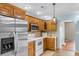 Spacious kitchen featuring a stainless steel refrigerator, white appliances, and wood cabinets, offering ample space at 1676 Elder Ln., Galivants Ferry, SC 29544
