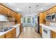 Bright kitchen featuring wood cabinets, stainless steel refrigerator, white appliances, and an adjacent breakfast nook at 1676 Elder Ln., Galivants Ferry, SC 29544