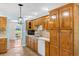 Well-lit kitchen featuring wooden cabinetry, laminate countertops, and a sink below a window with an archway at 1676 Elder Ln., Galivants Ferry, SC 29544