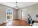 Versatile living room with arched doorway, large window, and hardwood floors for flexible layout at 1676 Elder Ln., Galivants Ferry, SC 29544