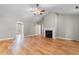 Bright living room featuring a fireplace, hardwood floors, and an open layout that seamlessly connects to other living spaces at 1676 Elder Ln., Galivants Ferry, SC 29544
