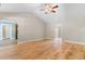 Open living room featuring hardwood floors, neutral wall paint, and arched doorways for versatile design options at 1676 Elder Ln., Galivants Ferry, SC 29544