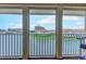 Inviting balcony showcasing a picturesque view of the lake and community buildings at 1900 Duffy St. # A8, North Myrtle Beach, SC 29582