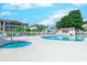 The community pool includes a hot tub surrounded by chairs and lounge chairs near the bathhouse at 1900 Duffy St. # A8, North Myrtle Beach, SC 29582