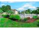 View of a fenced community pool from ground level showcasing lush landscaping and shrubbery at 1900 Duffy St. # A8, North Myrtle Beach, SC 29582