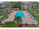 Aerial view of a fenced community pool surrounded by lounge chairs and manicured greenery at 1900 Duffy St. # A8, North Myrtle Beach, SC 29582
