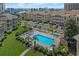 Aerial view of community pool with lounge chairs, palm trees, and beautiful landscaping in a desirable location at 1900 Duffy St. # A8, North Myrtle Beach, SC 29582