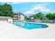 A bright community pool with ladder, surrounded by lounging chairs, a fence and bath house at 1900 Duffy St. # A8, North Myrtle Beach, SC 29582