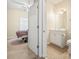 Connected bathroom with white vanity, neutral tile flooring, and convenient access to the primary bedroom at 200 Castle Dr. # 1369, Myrtle Beach, SC 29579