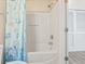 Bright bathroom featuring a shower with a white tub and ocean-themed curtain and a door with slat accents at 200 Castle Dr. # 1369, Myrtle Beach, SC 29579