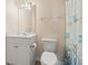 Cozy bathroom with a white vanity, ample lighting, and a shower with a fun, ocean-themed shower curtain at 200 Castle Dr. # 1369, Myrtle Beach, SC 29579