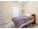 Bedroom with neutral walls and carpet, plus a bed with colorful patterned bedding and a side table at 200 Castle Dr. # 1369, Myrtle Beach, SC 29579