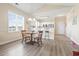 Cozy dining area with natural light adjacent to the kitchen featuring barstool seating and wood flooring at 200 Castle Dr. # 1369, Myrtle Beach, SC 29579