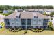 Exterior elevation of the condo building showcasing a well-maintained facade at 200 Castle Dr. # 1369, Myrtle Beach, SC 29579