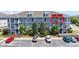 Three-story condominium building with multiple units, balconies, and lush landscaping at 200 Castle Dr. # 1369, Myrtle Beach, SC 29579