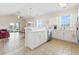 Bright open kitchen featuring white cabinetry, stainless steel appliances, and access to a dining and living area at 200 Castle Dr. # 1369, Myrtle Beach, SC 29579