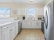 Bright kitchen featuring white cabinets, tiled floors, and stainless steel appliances at 200 Castle Dr. # 1369, Myrtle Beach, SC 29579
