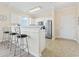 Stylish kitchen features stainless steel appliances, tiled floors, a breakfast bar, and access to the main entry at 200 Castle Dr. # 1369, Myrtle Beach, SC 29579