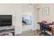 Living room with wood floors and a partial view of the bedroom through an interior door, plus a corner desk at 200 Castle Dr. # 1369, Myrtle Beach, SC 29579