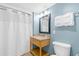 Bright bathroom with granite countertop vanity and a shower behind a white shower curtain at 2000 N Ocean Blvd. # 301, Myrtle Beach, SC 29577