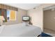 Comfortable bedroom featuring a queen bed, television, and a window providing natural light and outdoor views at 2000 N Ocean Blvd. # 301, Myrtle Beach, SC 29577