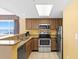 Cozy kitchen features wooden cabinets, stainless steel appliances, and granite countertops at 2000 N Ocean Blvd. # 301, Myrtle Beach, SC 29577