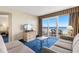 Relaxing living room with ocean view balcony access, plush sofas, and entertainment center at 2000 N Ocean Blvd. # 301, Myrtle Beach, SC 29577