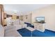 Bright living room featuring comfortable sofas, entertainment center, and adjoining kitchen and dining areas at 2000 N Ocean Blvd. # 301, Myrtle Beach, SC 29577