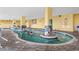 Indoor pool area with lounge chairs and stairs leading to upper floors at 2000 N Ocean Blvd. # 301, Myrtle Beach, SC 29577