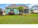 Well-maintained backyard with lush green lawn, landscaping, and charming screened-in porch at 2004 Crow Field Ct., Myrtle Beach, SC 29579