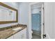 Bathroom features a granite countertop, stylish mirror, and colorful shower curtain at 2004 Crow Field Ct., Myrtle Beach, SC 29579
