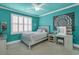 Stylish teal bedroom with a bed, vanity, and plenty of natural light at 2004 Crow Field Ct., Myrtle Beach, SC 29579