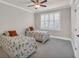 Bright bedroom features two twin beds, ceiling fan, and shuttered windows at 2004 Crow Field Ct., Myrtle Beach, SC 29579