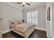 Cozy bedroom with a ceiling fan, a queen bed, shuttered window, and hardwood flooring at 2004 Crow Field Ct., Myrtle Beach, SC 29579