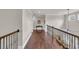 Second floor hallway with hardwood flooring, ornate banister, and bright lighting at 2004 Crow Field Ct., Myrtle Beach, SC 29579