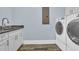 Laundry room with modern washer and dryer, granite counter, sink and hardwood flooring at 2004 Crow Field Ct., Myrtle Beach, SC 29579