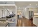 Open-concept living room features hardwood flooring, a wet bar, and stainless steel refrigerator at 2004 Crow Field Ct., Myrtle Beach, SC 29579