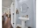 Stylish powder room featuring a pedestal sink, decorative mirror, and modern fixtures at 2004 Crow Field Ct., Myrtle Beach, SC 29579