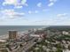 An aerial view highlights a beachfront community with ocean access, nearby green spaces, and low-rise condos at 204 Maison Dr. # N304, Myrtle Beach, SC 29572