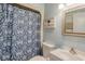 Neat bathroom with floral shower curtain, toilet, sink, and mirror at 204 Maison Dr. # N304, Myrtle Beach, SC 29572