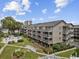 Aerial view of condo community surrounded by trees and lush landscaping with walkways and a community pool on a sunny day at 204 Maison Dr. # N304, Myrtle Beach, SC 29572