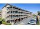 Exterior view of a multi-story building with parking, accessed by stairs at 204 Maison Dr. # N304, Myrtle Beach, SC 29572