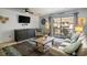 Comfortable living room with a TV, balcony access, and a cozy seating area at 204 Maison Dr. # N304, Myrtle Beach, SC 29572