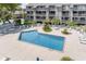 Aerial view of outdoor pool with surrounding condos, patio area, and lush landscaping at 206 Maison Dr. # Q-204, Myrtle Beach, SC 29572
