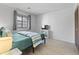Cozy bedroom featuring a comfortable bed, television, neutral walls and hardwood flooring at 206 Maison Dr. # Q-204, Myrtle Beach, SC 29572