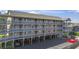 Exterior view of a multi-level condo building with wooden walkways and support beams over a parking area at 206 Maison Dr. # Q-204, Myrtle Beach, SC 29572