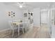 Bright dining room with white table and chairs, complemented by modern flooring at 206 Maison Dr. # Q-204, Myrtle Beach, SC 29572