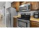 Well-equipped kitchen featuring stainless steel appliances, wood cabinetry, and a laminate counter at 206 Maison Dr. # Q-204, Myrtle Beach, SC 29572