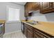 Galley kitchen with wood cabinets, updated stainless steel appliances, and laminate countertops at 206 Maison Dr. # Q-204, Myrtle Beach, SC 29572