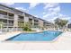 Outdoor swimming pool with lounge chairs surrounded by lush landscaping and condos in the background at 206 Maison Dr. # Q-204, Myrtle Beach, SC 29572